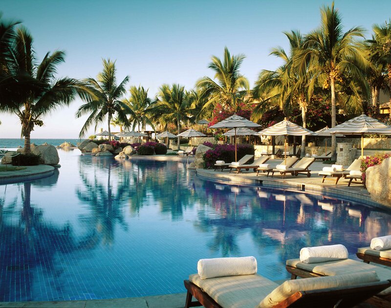 Infinity Pool at Resort — Blue, Serene, Afternoon, Photograph, Palm Trees, Lounge Chairs, Umbrellas
