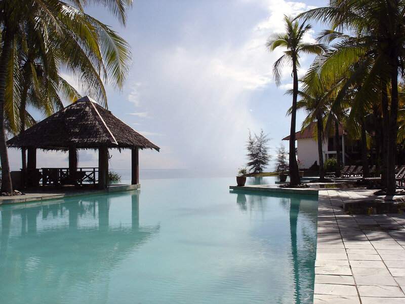 Infinity Pool at Resort — Blue, Serene, Afternoon, Photograph, Palm Trees, Thatched Gazebo