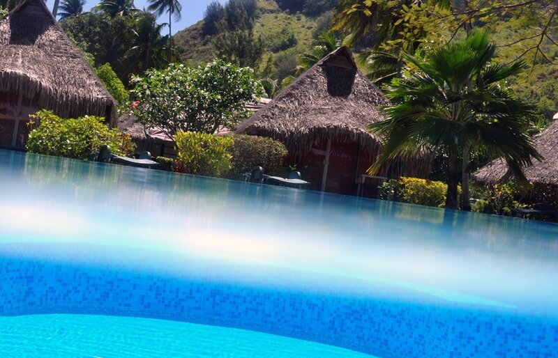 Infinity Pool at Resort — Blue, Serene, Afternoon, Photograph, Thatched Huts, Palm Trees