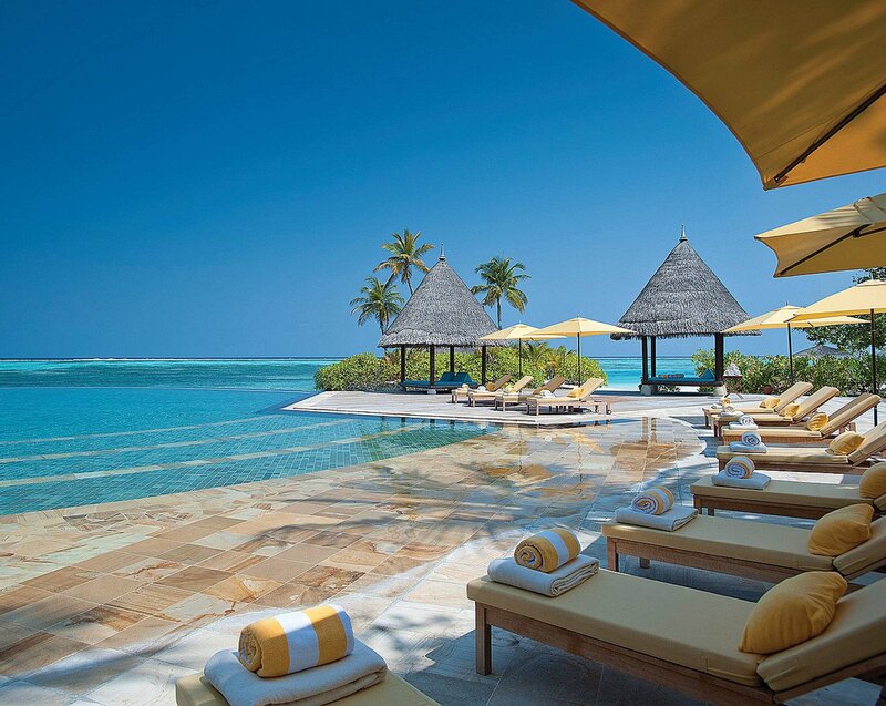Infinity Pool at Resort — Blue, Serene, Afternoon, Photograph, Tiki Huts