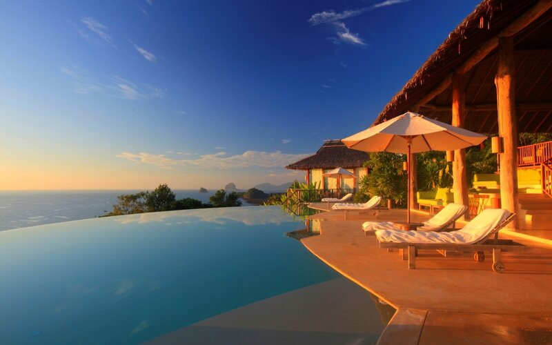 Infinity Pool at Resort — Blue, Serene, Sunset, Photograph, Lounge Chairs, Umbrella, Ocean