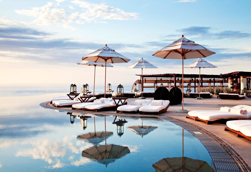 Infinity Pool at Resort — Blue, Serene, Sunset, Photograph, Umbrellas