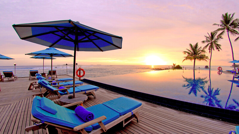 Infinity Pool at Sunset — Blue, Serene, Photograph, Lounge Chairs, Umbrellas, Palm Trees