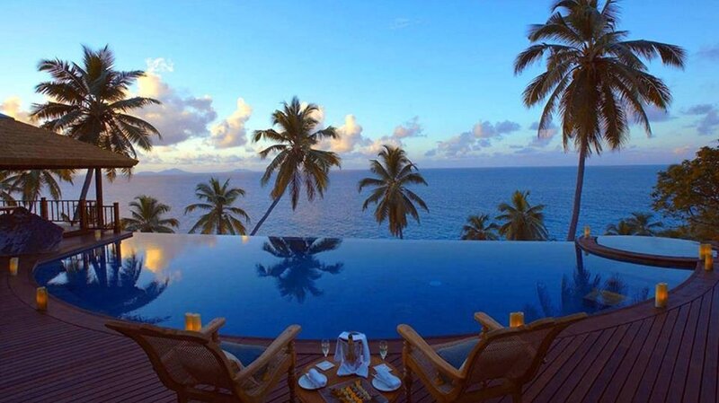 Infinity Pool at Sunset — Blue, Serene, Photograph, Palm Trees, Ocean, Deck Chairs, Candles