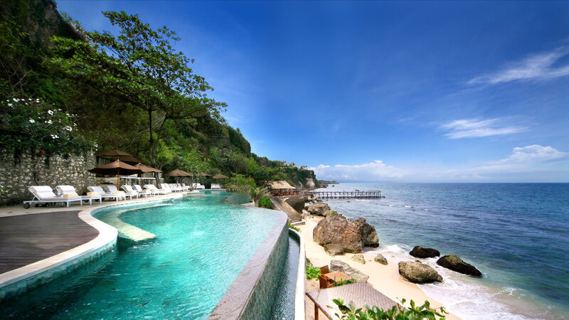 Infinity Pool Overlooking Ocean — Blue, Serene, Afternoon, Photograph, Lounge Chairs, Umbrellas