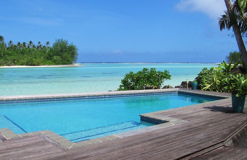 Infinity Pool Overlooking Ocean — Blue, Serene, Afternoon, Photograph, Palm Trees, Deck