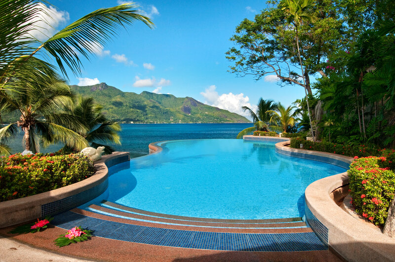 Infinity Pool Overlooking Ocean — Blue, Serene, Afternoon, Photograph, Palm Trees, Mountain, Flowers