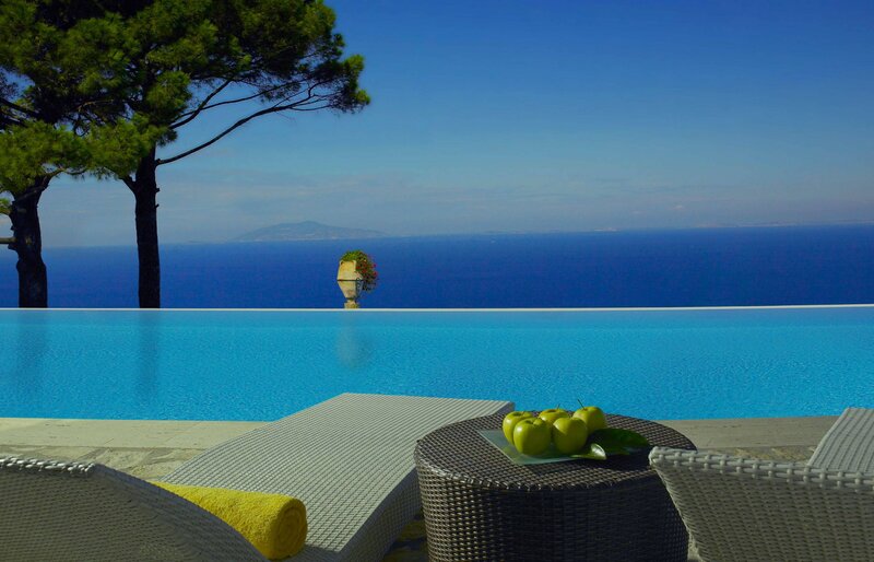 Infinity Pool Overlooking Sea — Blue, Serene, Afternoon, Photograph, Trees