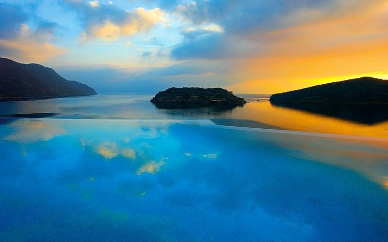 Infinity Pool Overlooking Sea — Blue, Serene, Sunset