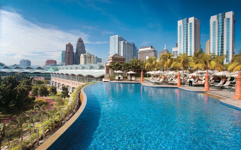 Infinity Pool with City View — Blue, Serene, Afternoon, Photograph, Skyscrapers, Palm Trees, Lounge Chairs, Green, White