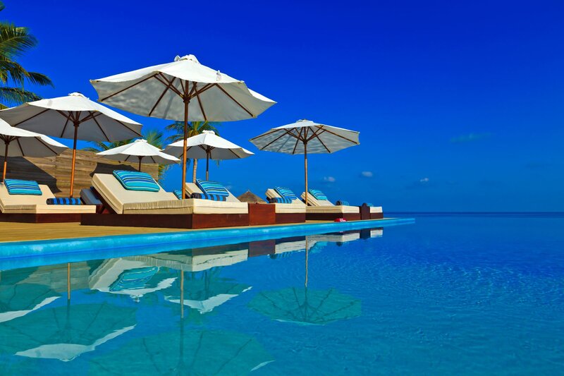 Infinity Pool with Lounge Chairs — Blue, Serene, Afternoon, Photograph, Umbrellas, Palm Trees