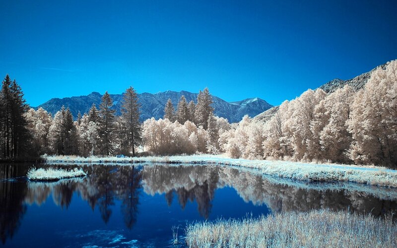 Infrared landscape with lake and mountains