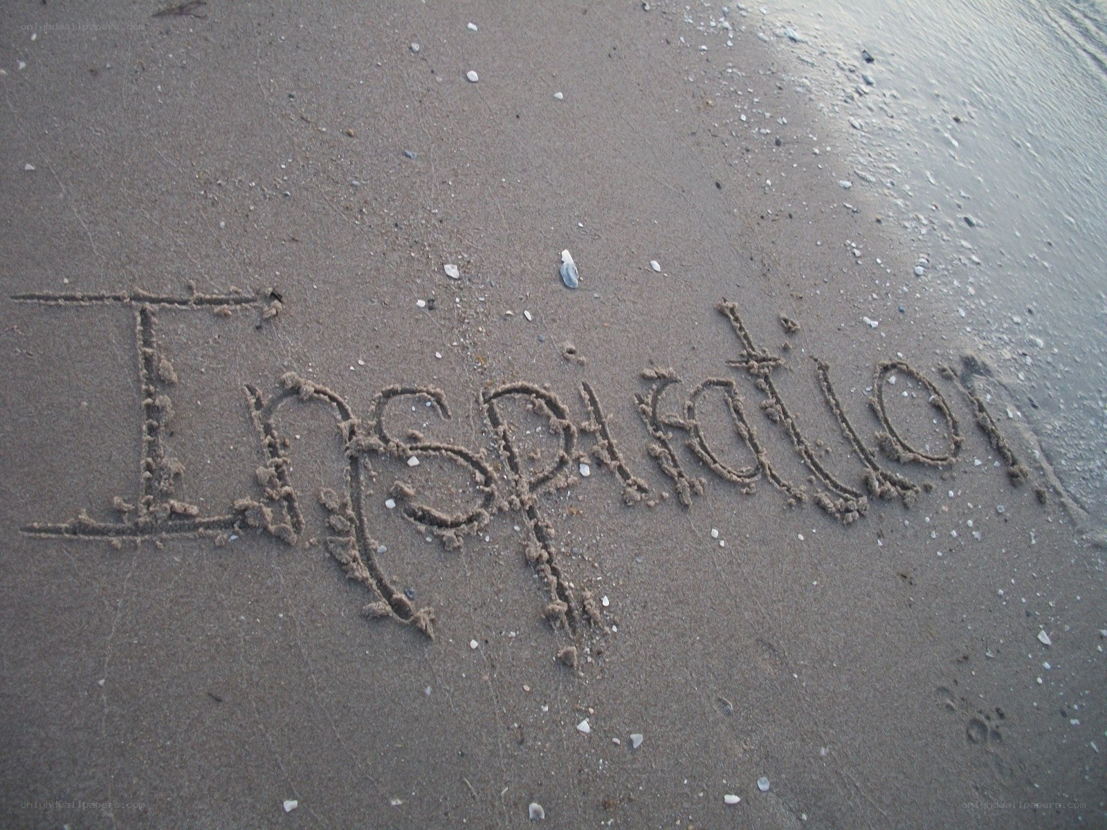 Inspiration written in the sand