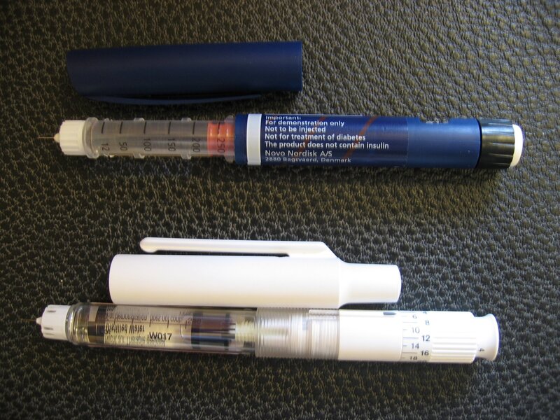 Insulin pens on textured surface