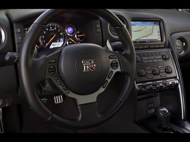 Interior of a Sports Car — Black, Modern, Photograph, Steering Wheel, Dashboard, Infotainment Screen