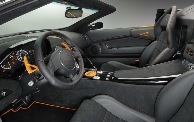 Interior of a Sports Car — Black, Sleek, Photograph, Steering Wheel, Dashboard, Seats, Gray