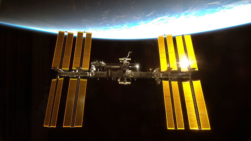 International Space Station — Black, Dramatic, Night, Photograph, Solar Panels, Earth, Yellow, Blue