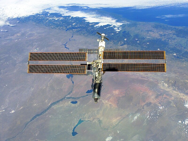International Space Station — Blue, Serene, Photograph, Solar Panels, Earth, Clouds, Brown