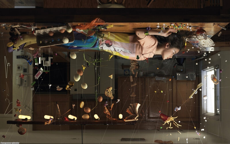 Inverted kitchen scene with floating objects
