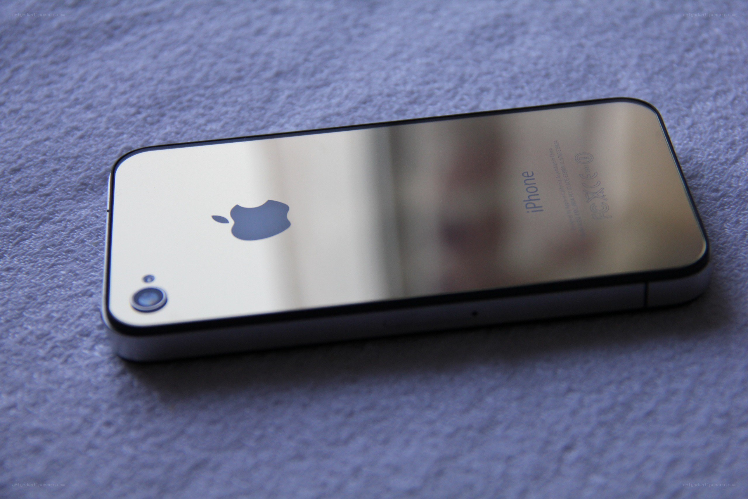 iPhone 4 on a blue surface