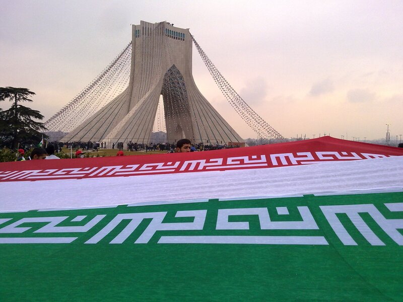 Iranian flag in front of Azadi Tower