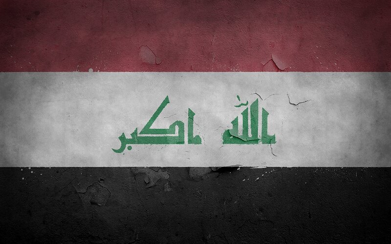 Iraqi flag on weathered wall