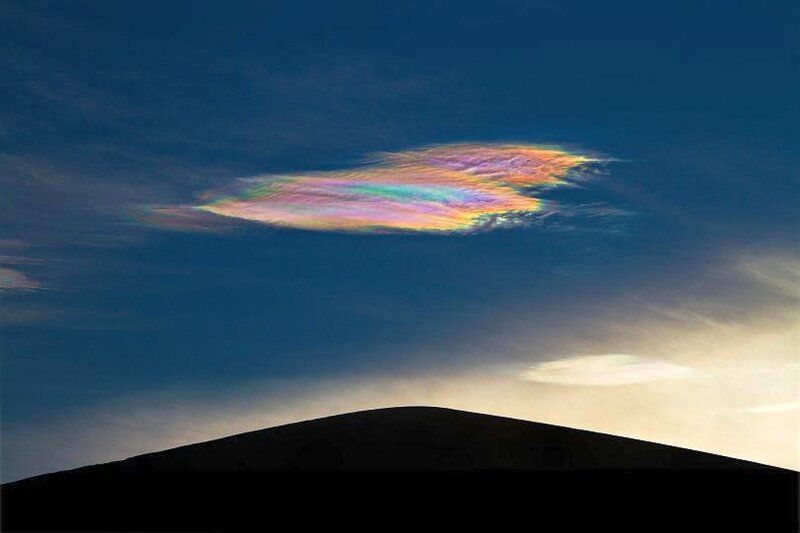 Iridescent cloud over mountain