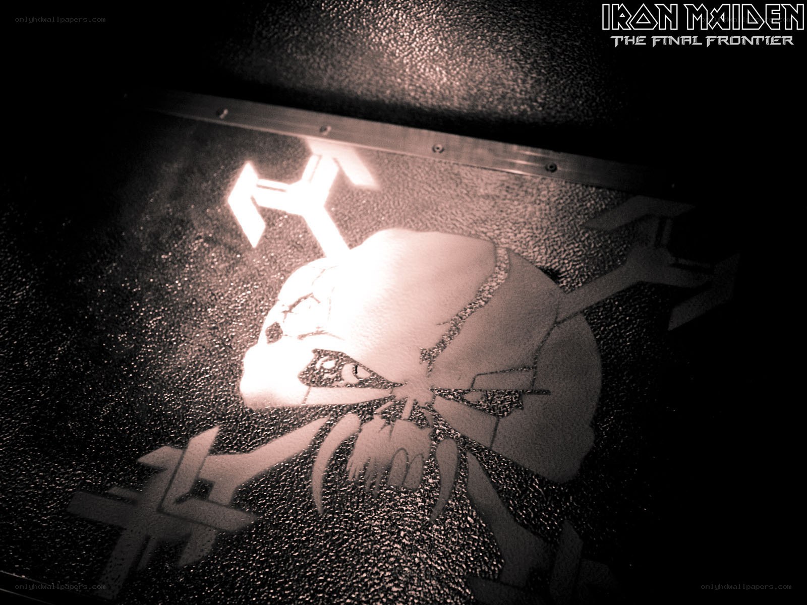 Iron Maiden logo on textured surface