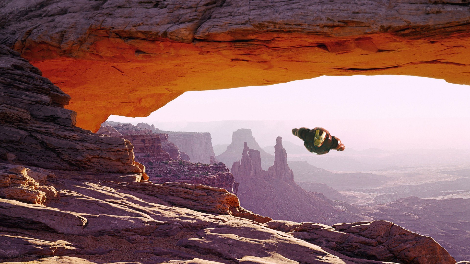 Iron Man flying through a canyon arch