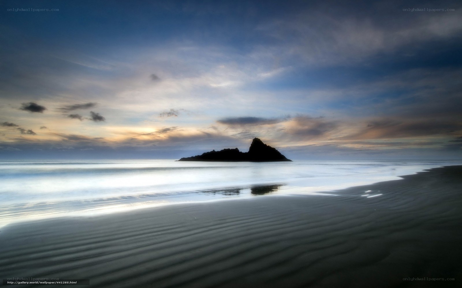 Island at dusk on a calm beach