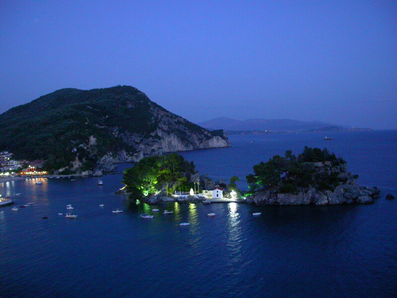 Island at dusk with boats