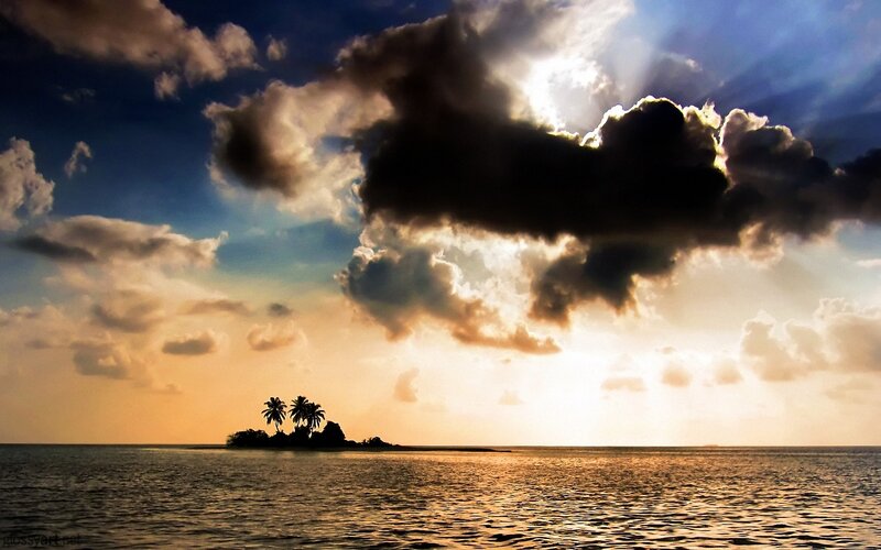Island at sunset with dramatic clouds