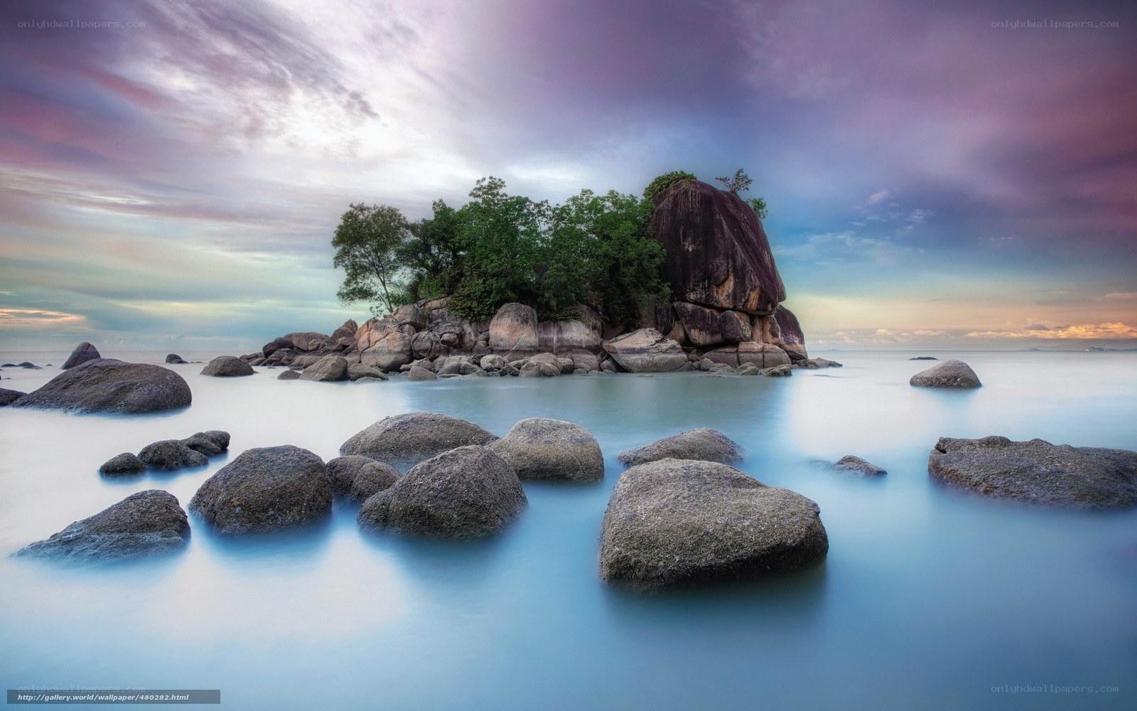 Island at sunset with rocks