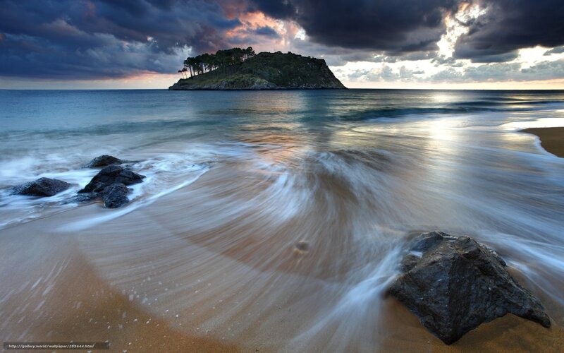 Island at sunset with waves