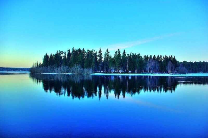 Island in a calm lake at dusk