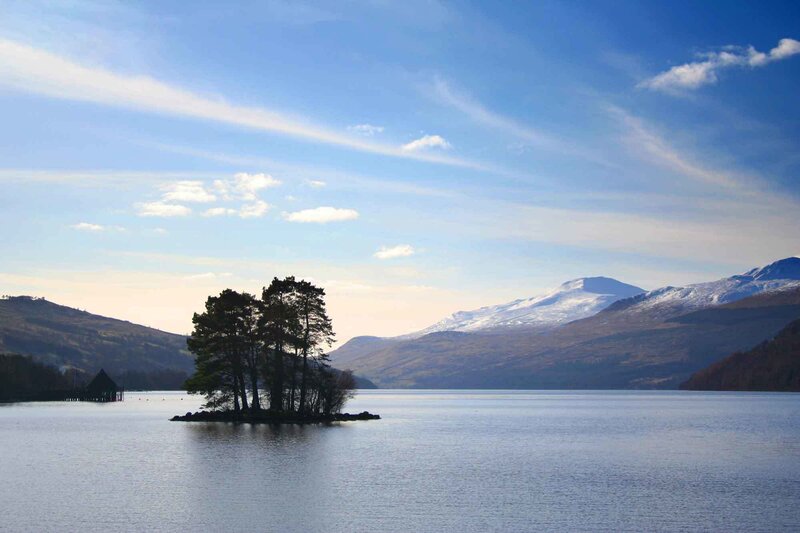 Island in a lake with mountains
