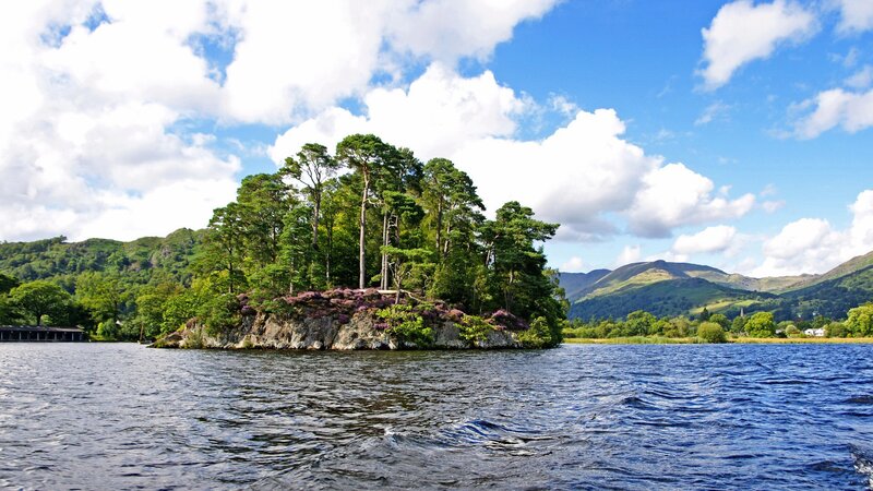 Island in a lake with mountains