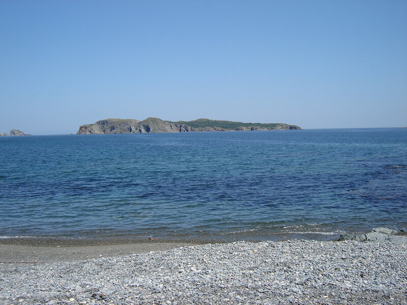 Island in Blue Sea — Serene, Afternoon, Photograph, Pebble Beach