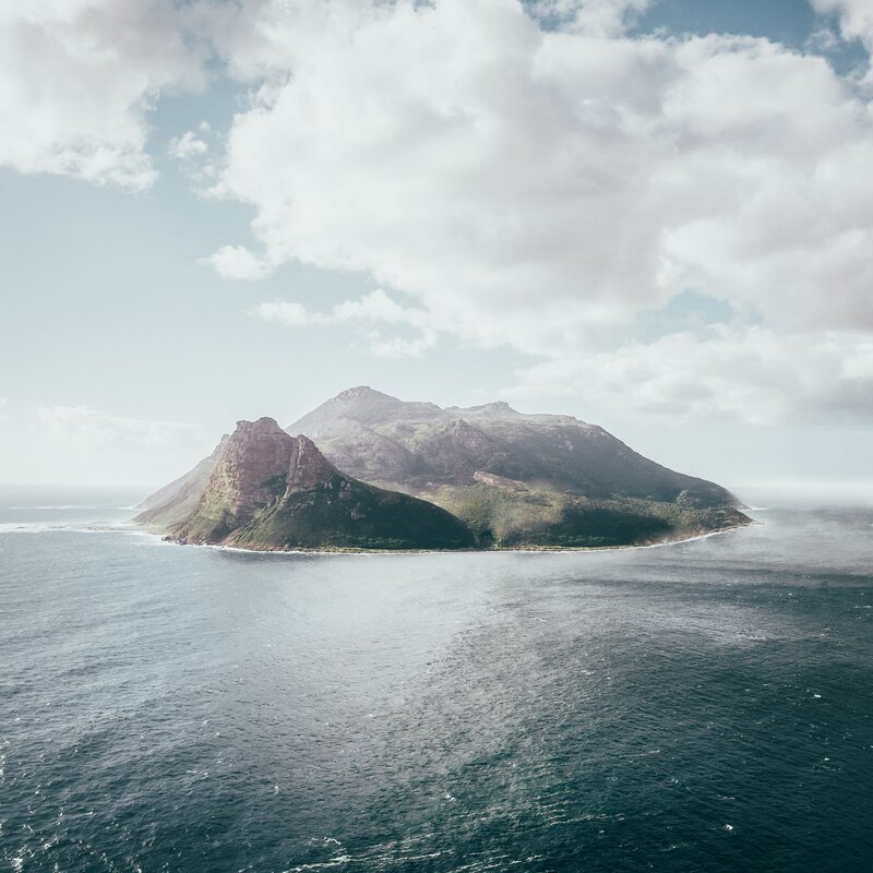 Island in Ocean — Blue, Serene, Afternoon, Photograph, Mountain, Clouds
