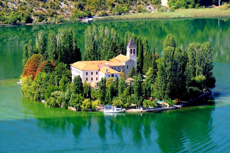 Island monastery on a green lake