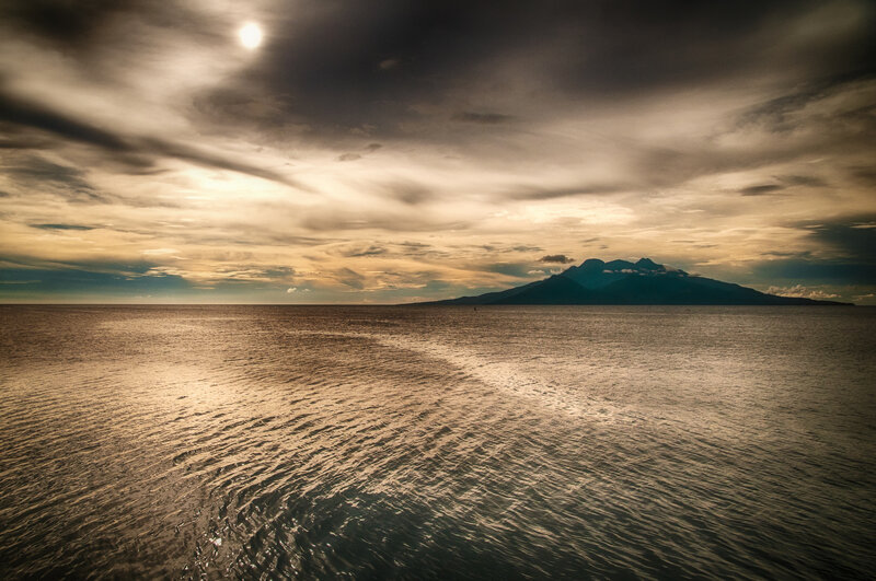 Island Silhouette at Sea — Brown
