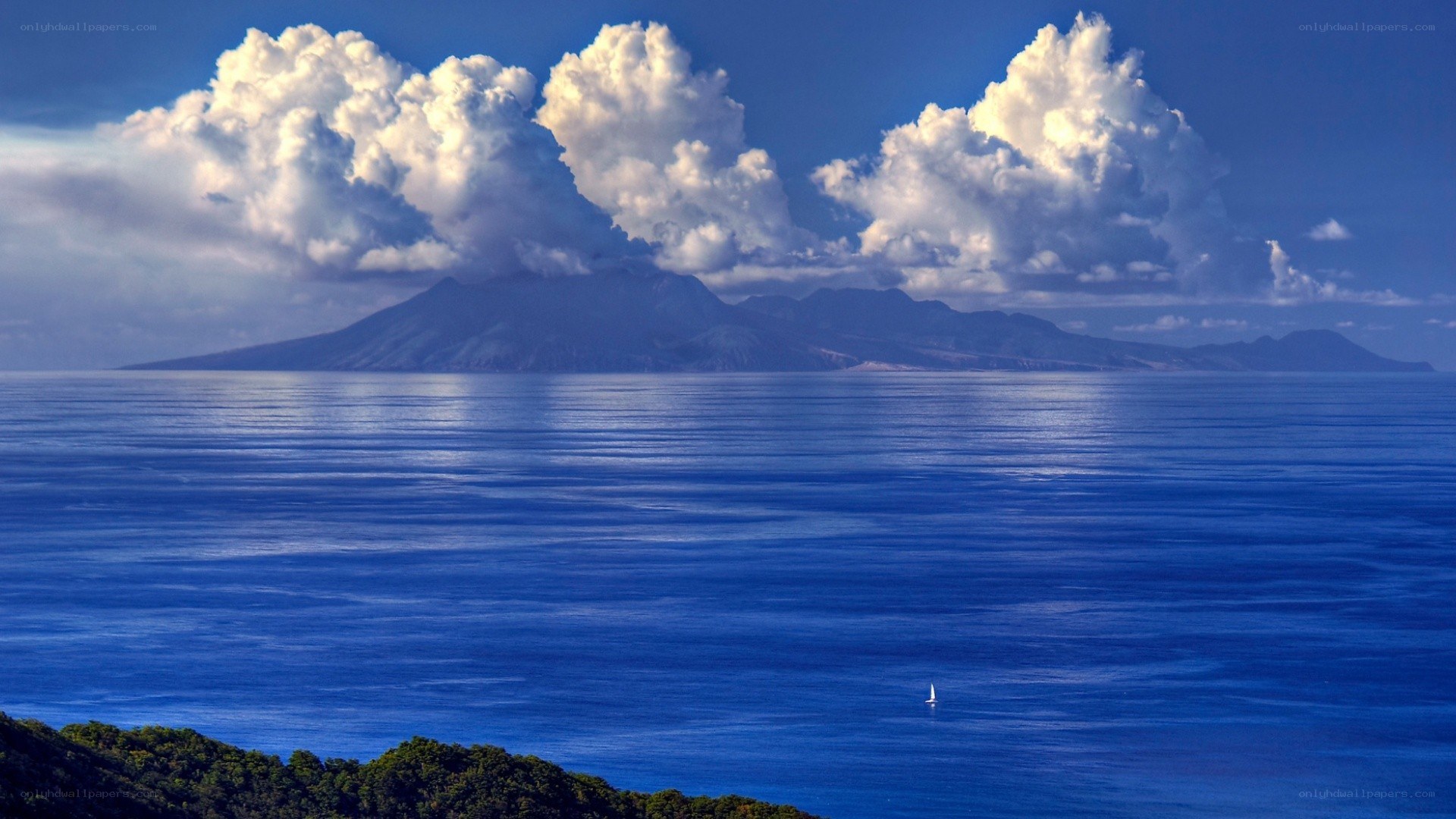 Island with clouds and sailboat