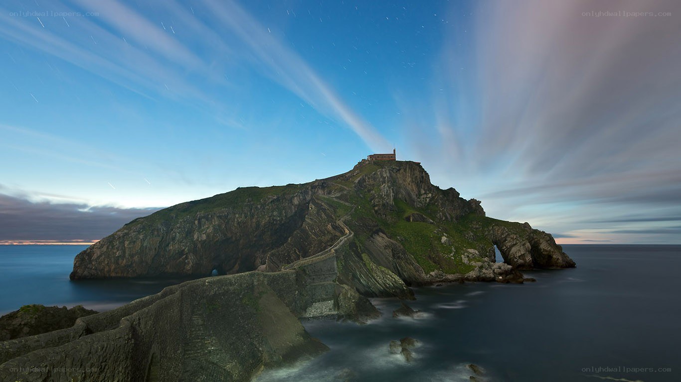 Island with lighthouse at night