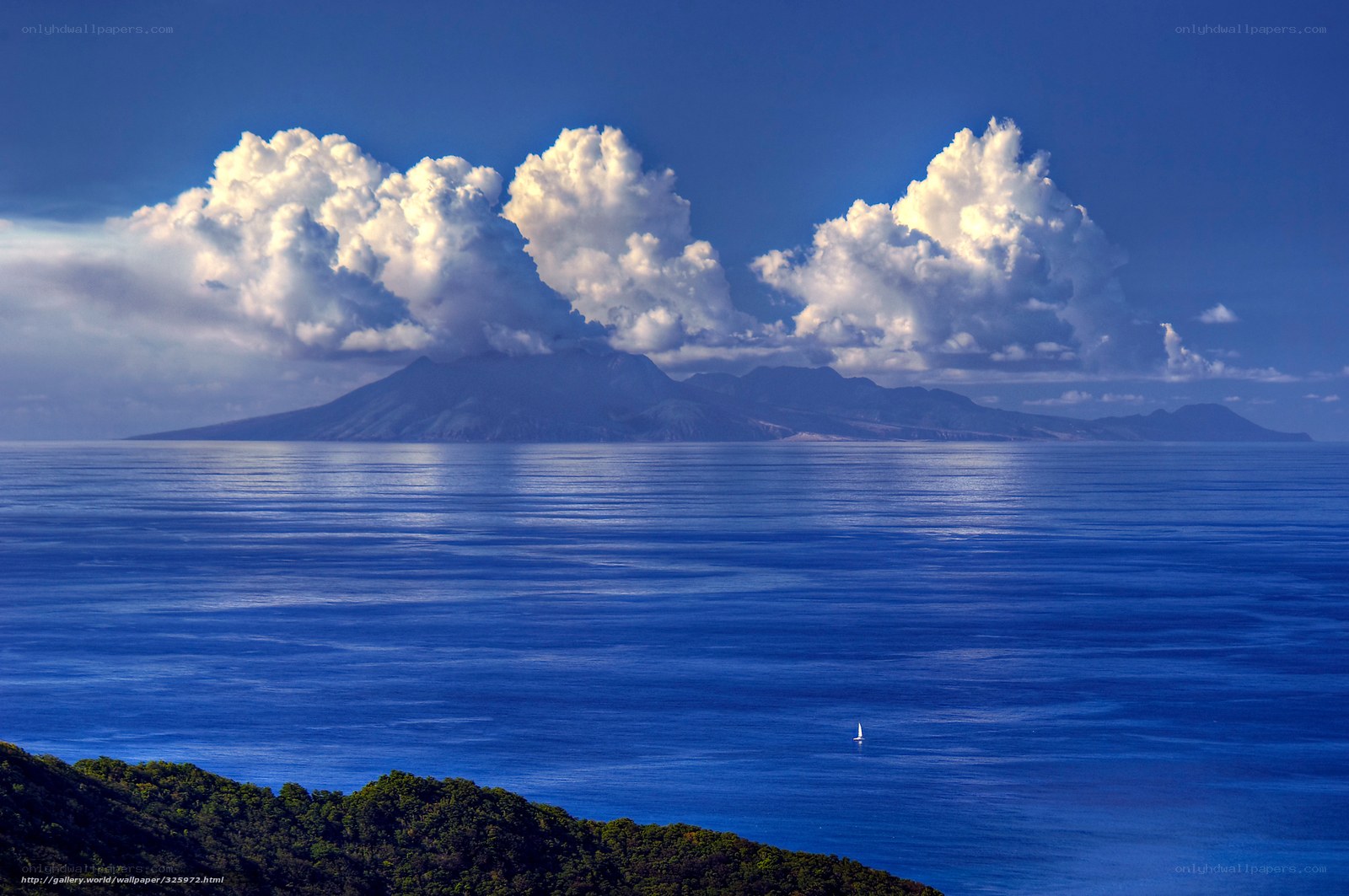 Island with sailboat and clouds