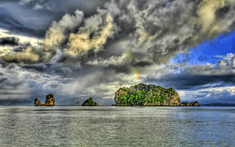 Islands under stormy sky with rainbow