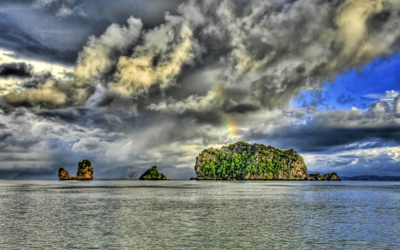 Islands under stormy sky with rainbow