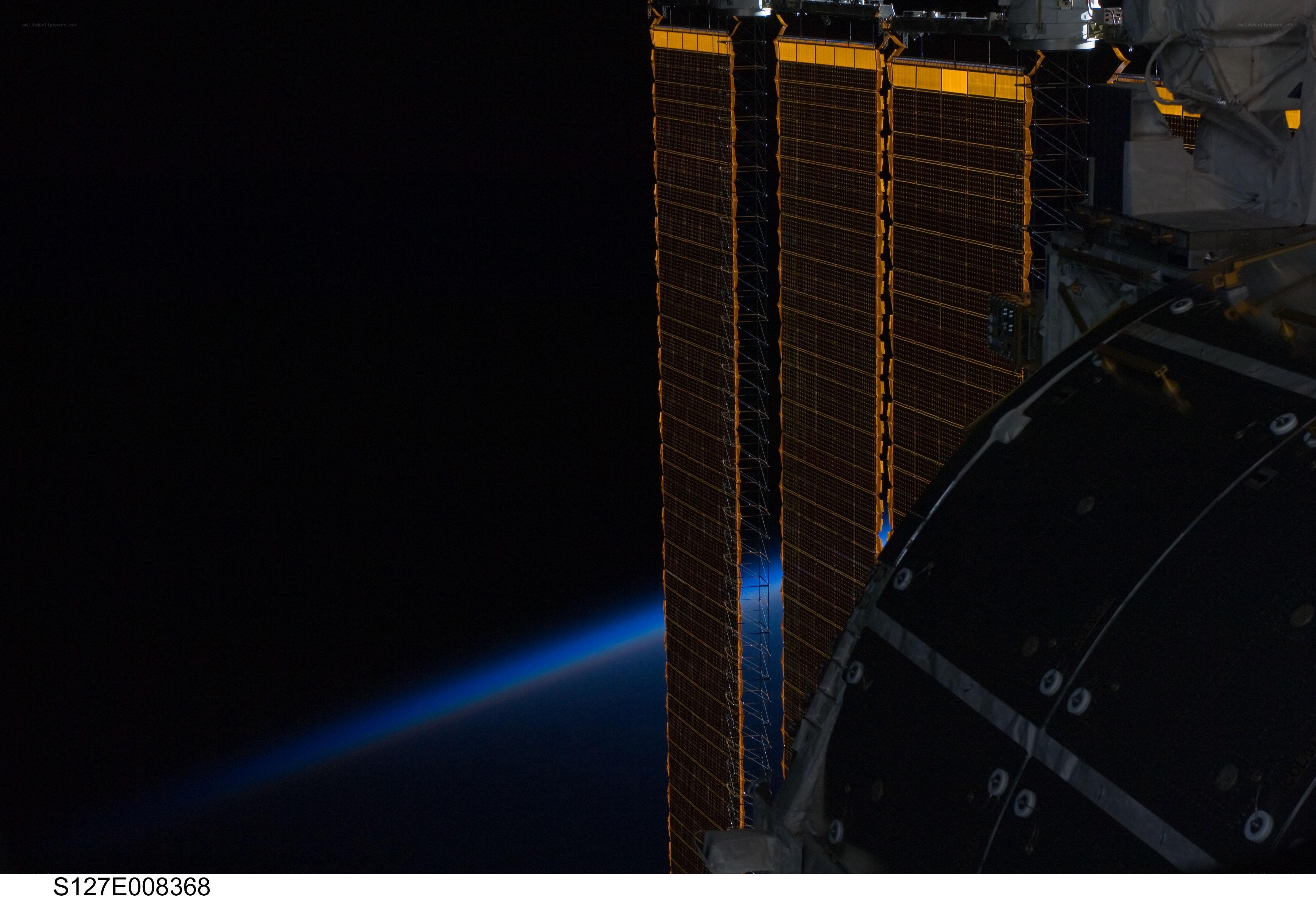 ISS solar arrays over Earth
