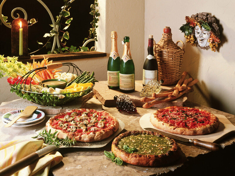 Italian meal with pizzas and wine