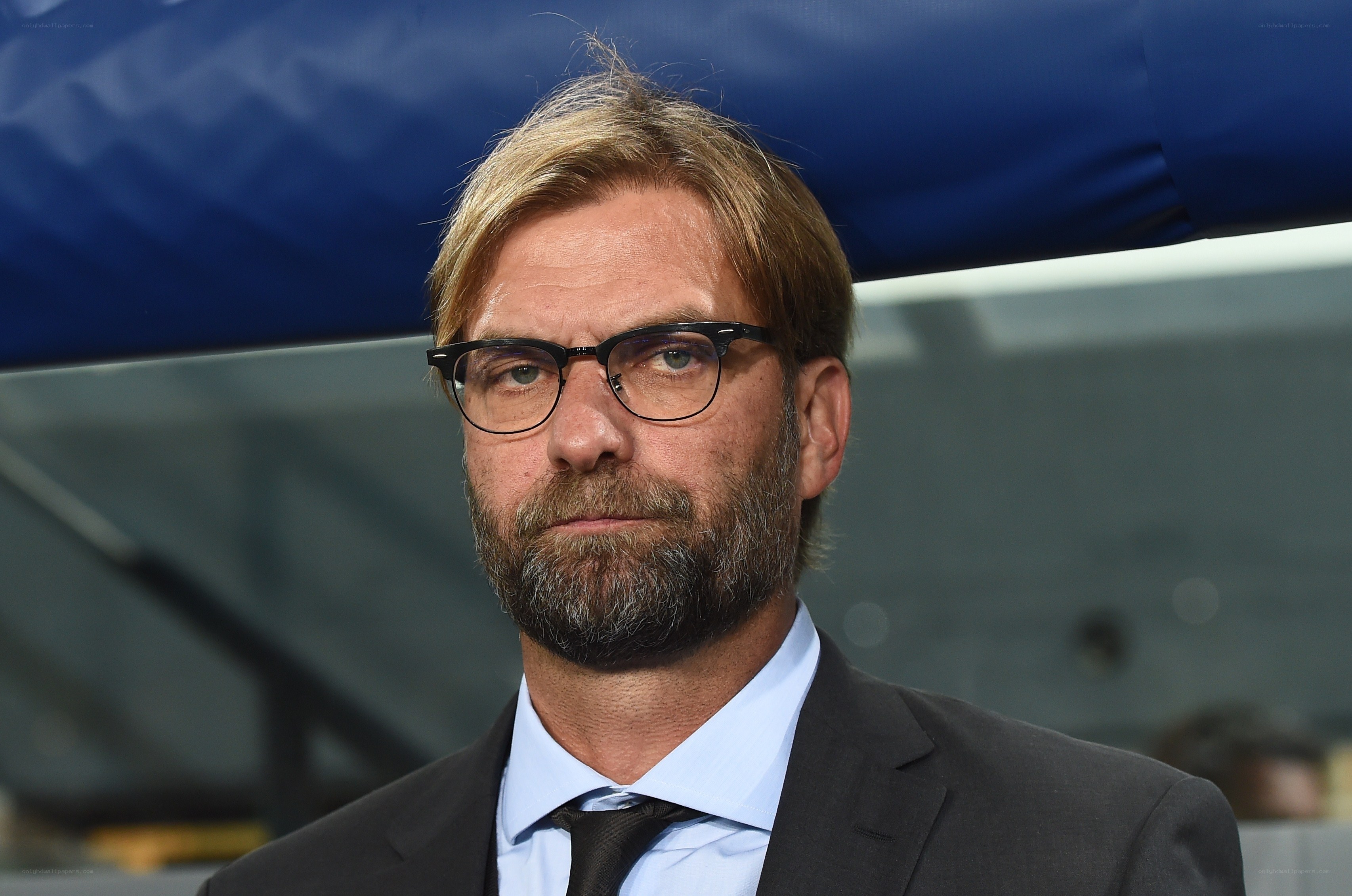 Jürgen Klopp in suit and glasses
