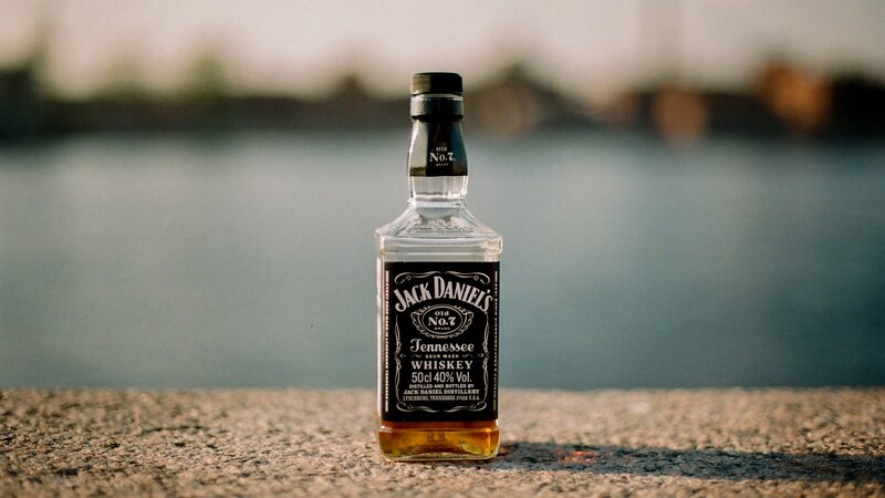 Jack Daniel's bottle by water